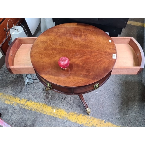 450 - A Mahogany circular Victorian sdrum table with brass lion head drawer pulls and claw feet tripod leg... 