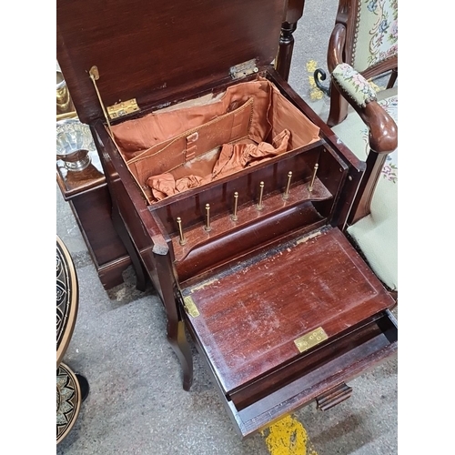 453 - A Mahogany Edwardian sewing table with cabriole legs. The top opening to reveal a lined interior. 
M... 