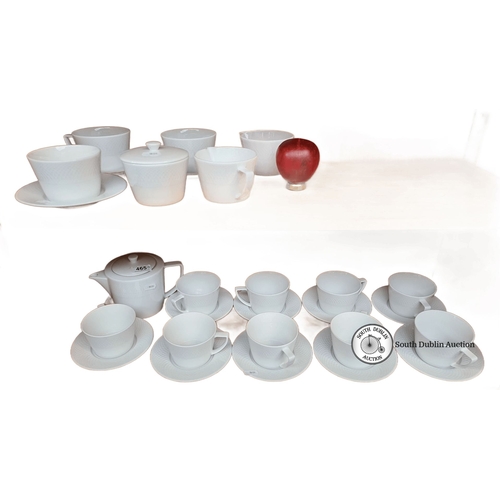 465 - A Dema Designs porcelain tea set includes 12 cups, 12 saucers, a creamer, a sugar bowl, and a teapot... 