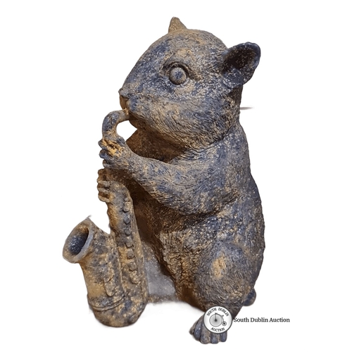 468 - A heavy cast metal sculpture of an animal playing saxophone. Earthy tones with textured details.