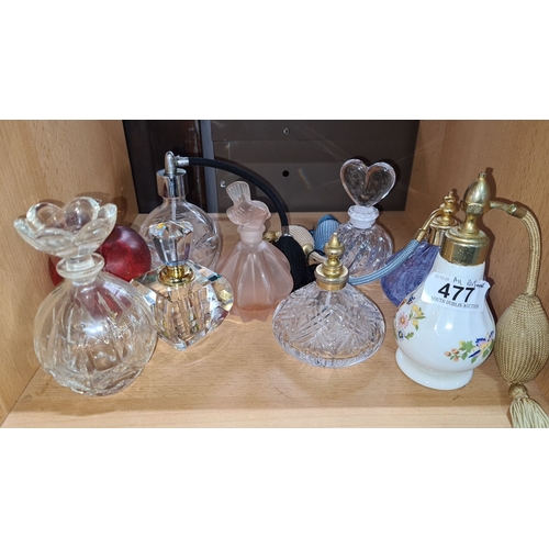 477 - Collection of vintage glass perfume bottles, featuring various crystal designs and floral porcelain ... 