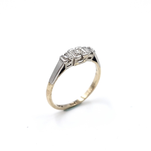 10 - Star Lot : A pretty nine carat gold and platinum diamond ring. Size - M 1/2. Weight - 1.78 grams.