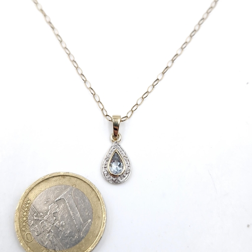 11 - Star Lot : A nine carat blue topaz and diamond pendant necklace set with link chain. Length - 46 cms... 