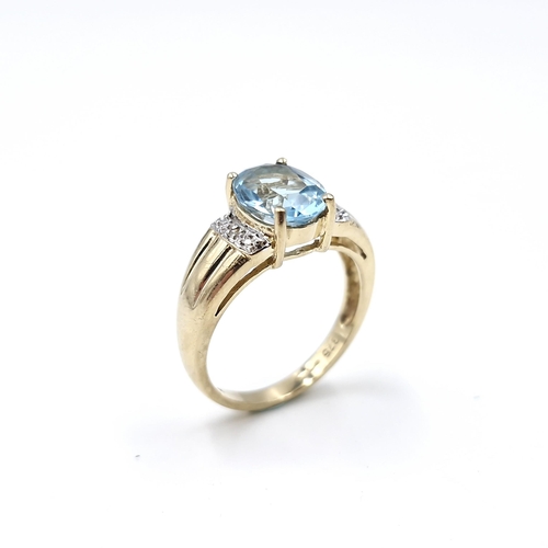 12 - Star Lot : A fabulous large blue topaz and diamond ring set in nine carat gold. Ring size - L 1/2. W... 