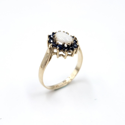 2 - Star Lot : A pretty nine carat gold opal stone ring with sapphire stone surround. Ring size - M 1/2.... 