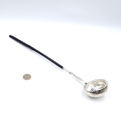 26 - A sterling silver bowl toddy ladle with twist ebony stem. Marked 925 Length - 31 cms. Total weight -... 