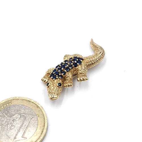 29 - Star Lot : A nice example of a nine carat gold hallmarked crocodile brooch. Set with blue sapphire b... 