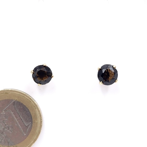 4 - A pair of nine carat gold smoky quartz stud earrings. Weight - 1.78 grams.