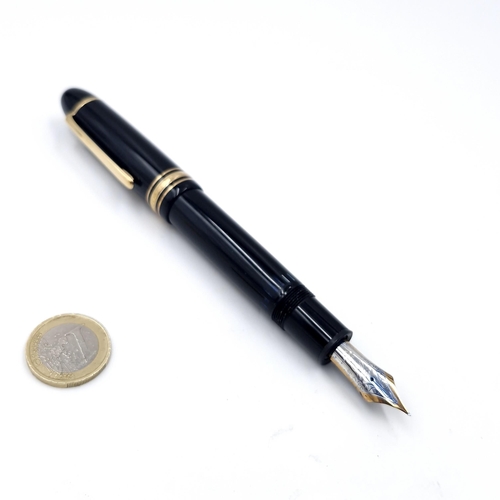 56 - Star Lot : A Mont Blanc fountain pen with a 14 carat (585) nib set with gold toned detailing.