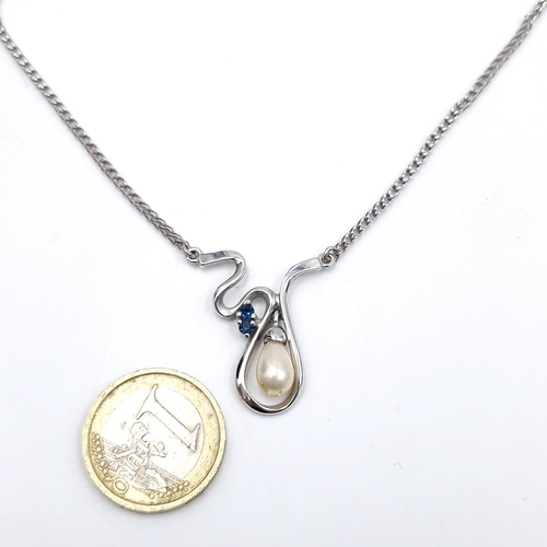 58 - A pearl and gem set (topaz) pendant with chain. Length of chain - 36 cms. Weight - 6.48 grams. Boxed... 