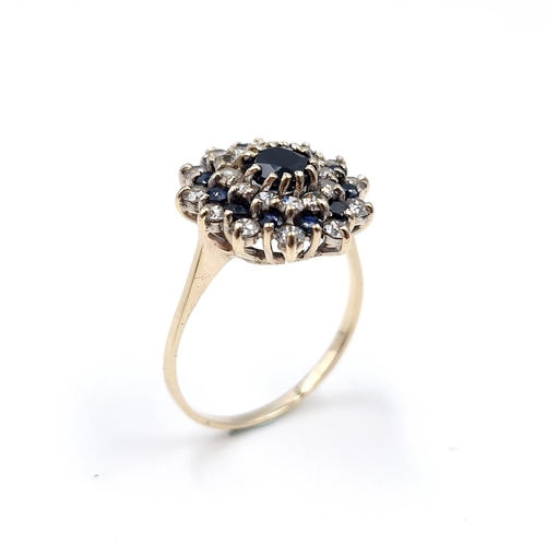 7 - Star Lot : A large vintage sapphire and diamond cluster ring set in nine carat gold. Size - V. Weigh... 