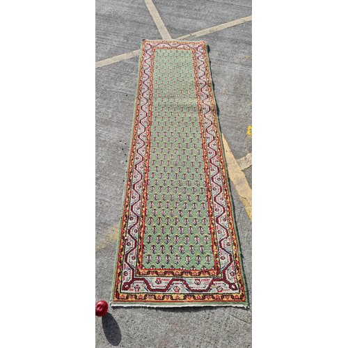 692 - Star Lot: An exquisite example of a hand knotted 100% wool pile runner rug, made in India. The tones... 