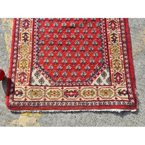 693 - Star Lot: A beautiful long hand knotted, Indian made, runner rug. A vibrant piece, predominantly in ... 