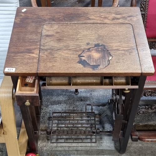 621 - Oak wood antique treadle sewing machine and table, approximately 30 inches high, 24 inches wide, 18 ... 