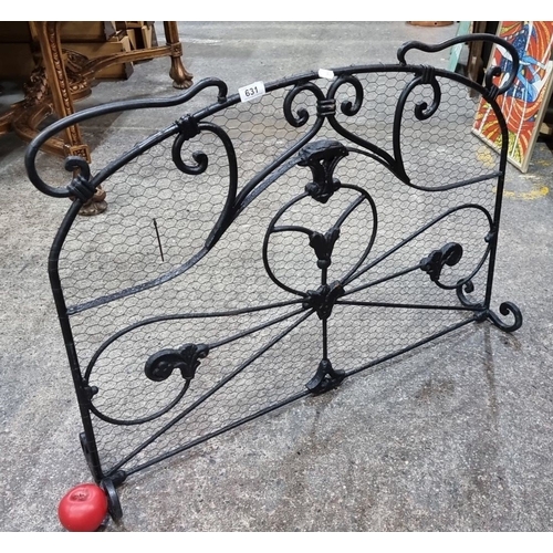 631 - Star Lot : A heavy Wrought iron fireplace screen with intricate scrollwork design. Approximately 70c... 