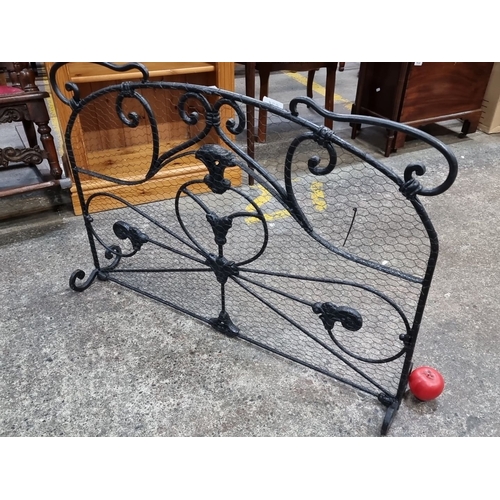 631 - Star Lot : A heavy Wrought iron fireplace screen with intricate scrollwork design. Approximately 70c... 