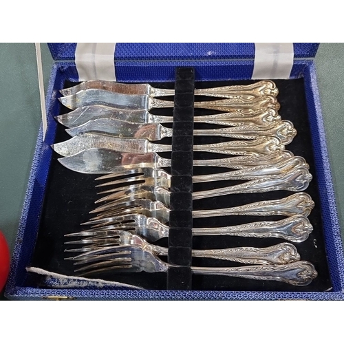 636 - Set of 12 silver-plated fish forks and knives in ornate design, presented in a blue case.