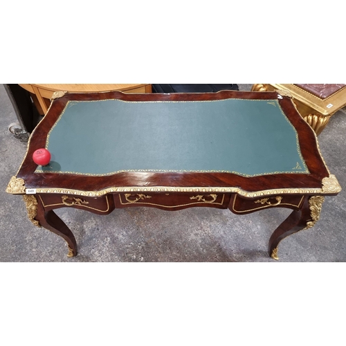 649 - Star Lot : A French Mahogany desk with green leather inlay top, ornate gilt bronze ormolu mounts, an... 