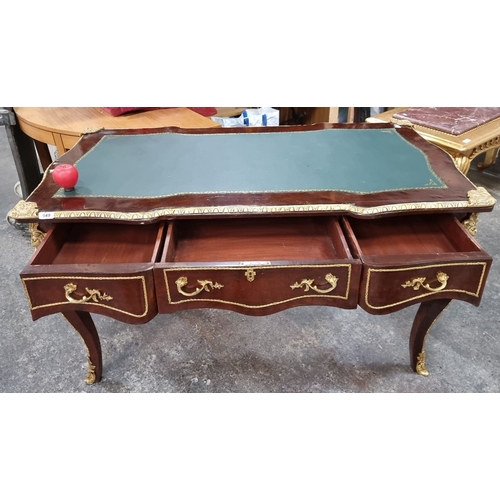 649 - Star Lot : A French Mahogany desk with green leather inlay top, ornate gilt bronze ormolu mounts, an... 