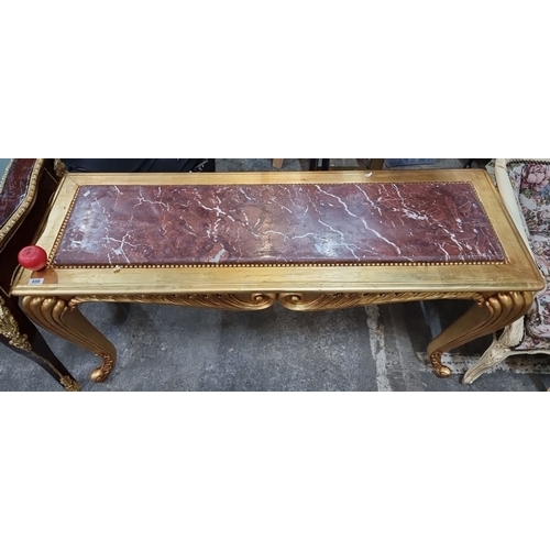 650 - Star Lot : A beautifully Gilded console table with a red cold Italian marble top featuring ornate sc... 