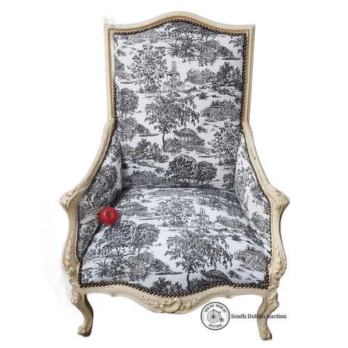 652 - Star Lot : Ornate Louis XV-style armchair featuring toile de Jouy upholstery and carved wood frame. ... 