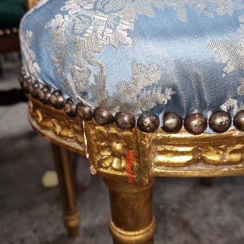 656 - Star Lot : A stunning Pair of Louis XVI-style gilded side chairs with ornate carving. Upholstered in... 