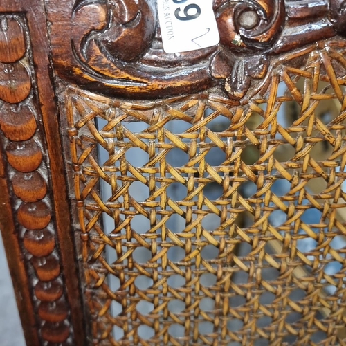 659 - Star Lot : Pair of British Regency-style carved  chairs with caned backs and green upholstered seats... 