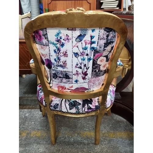 663 - Star lot : An Ornate armchair with gilded wood frame and vibrant patchwork upholstery featuring flor... 