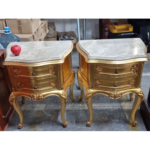 666 - Star Lot : A fabulous pair of ornate gilded side tables with cold Italian marble tops, featuring cab... 