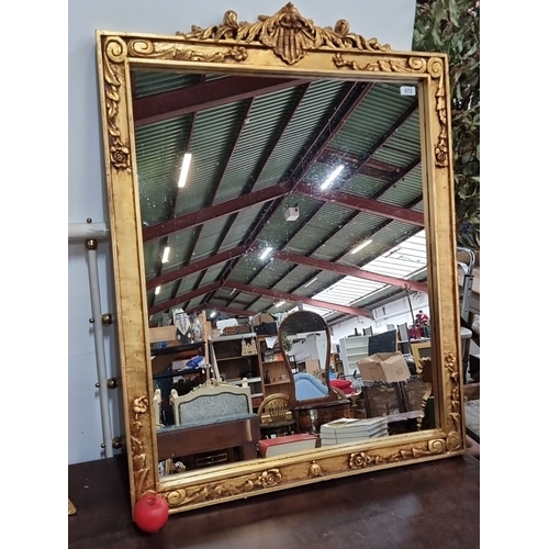 672 - Star Lot : A very impressive Giltwood mirror with ornate floral and scroll detailing. Approximately ... 