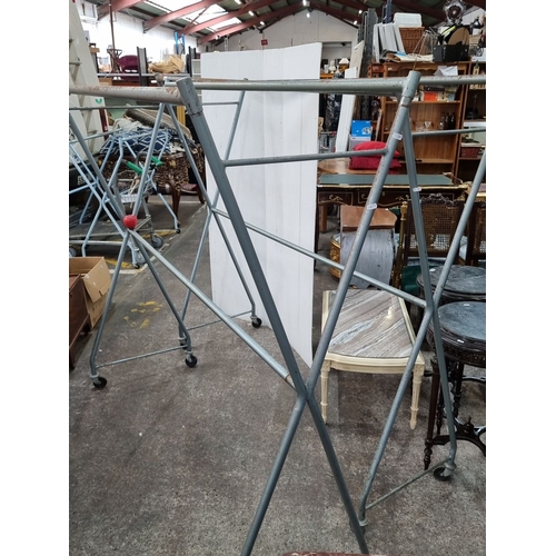 674 - Two very large vintage metal rolling garment rack with an angular frame. Approximately 180 cm high, ... 