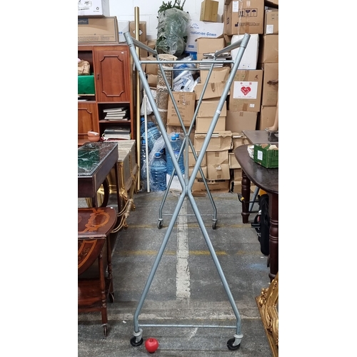 674 - Two very large vintage metal rolling garment rack with an angular frame. Approximately 180 cm high, ... 