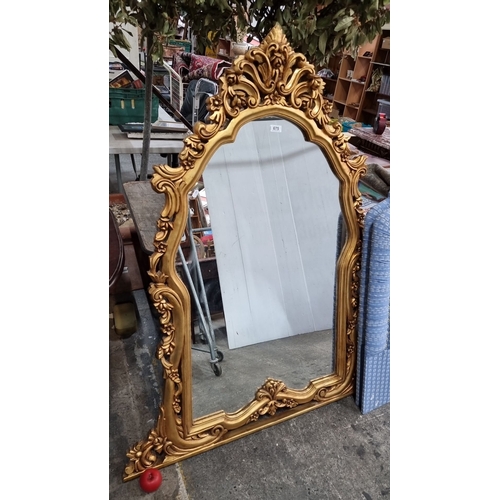 675 - Ornate Baroque-style gilded mirror with intricately carved floral motifs. Approximately 150 cm tall,... 