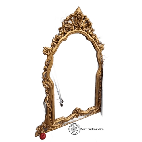 675 - Ornate Baroque-style gilded mirror with intricately carved floral motifs. Approximately 150 cm tall,... 