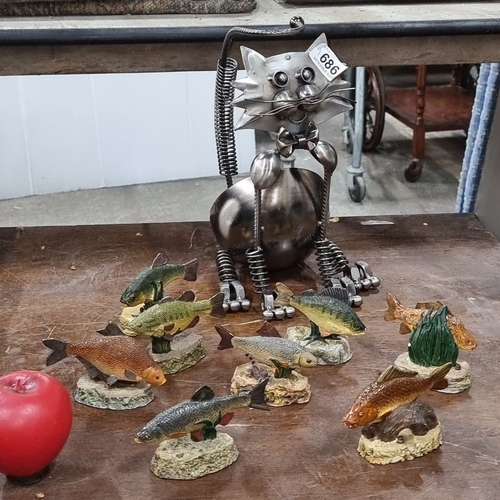 686 - Metal cat sculpture with nine resin fish figurines, including 