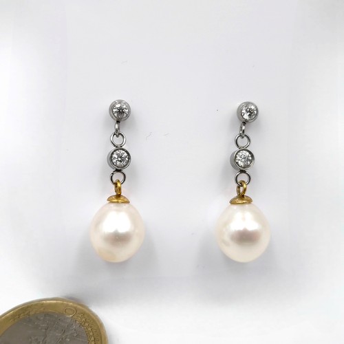 602 - Star Lot : A pair of 18 carat gold diamond (Approx 0.80cts)  & AKOYA pearl stud drop earrings. Total... 