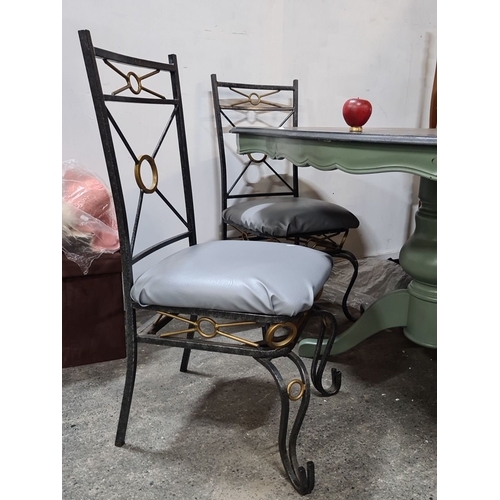 853 - Star lot: Dining set with wrought iron chairs featuring geometric accents and upholstered seats. The... 