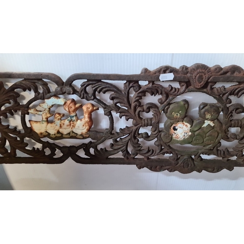 861 - Cast iron bench backrest with intricate scrollwork and painted animal motifs. Approximately 120 cm w... 