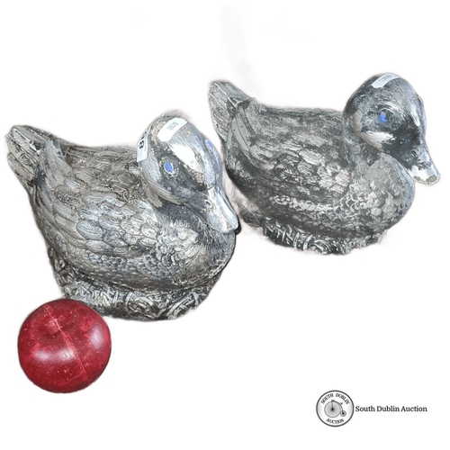 862 - Pair of stone  duck sculptures with textured feather detail and painted eyes. Approximately 10 inche... 