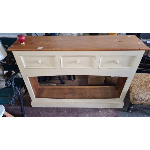 869 - Pine kitchen console with cream painted finish, featuring three drawers. Approximately 80cm high, 12... 