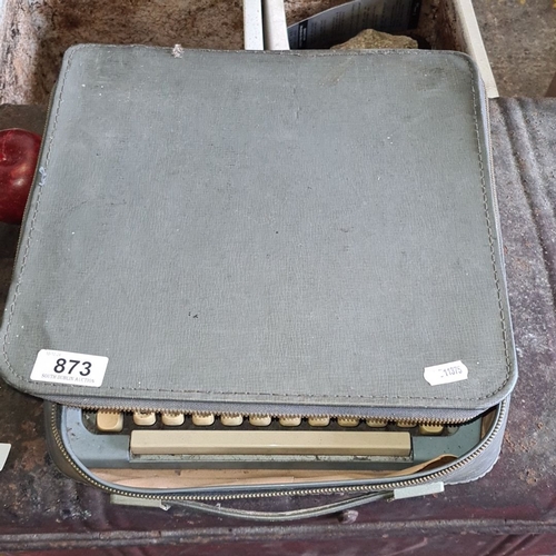 873 - Vintage Brother De Luxe typewriter in a carry case, featuring cream keys and a pale blue body.