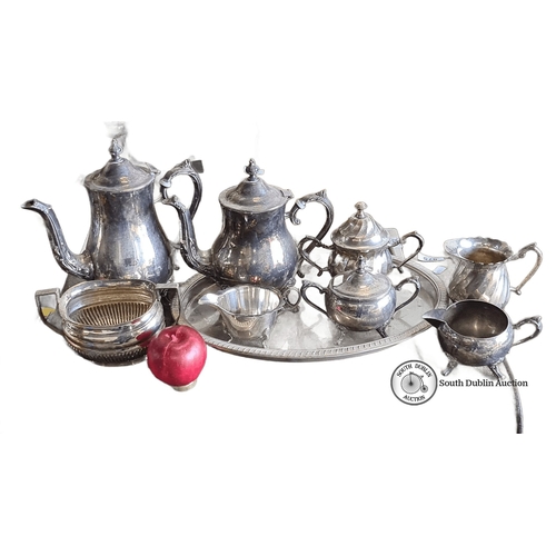 876 - Silver-plated tea and coffee service set includes a teapot, coffee pot, sugar bowl, creamer, waste b... 