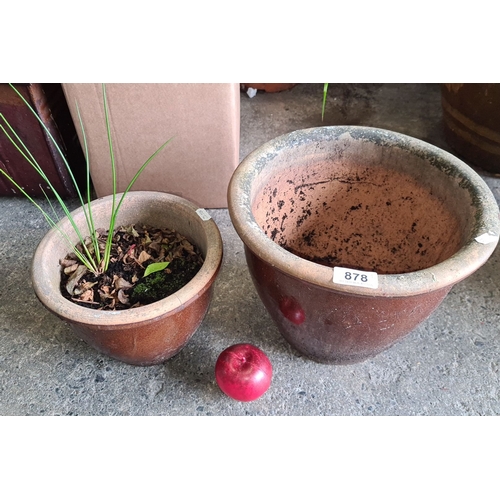 878 - Set of two brown terracotta planters, one with foliage. Rustic finish. Approximately 10 inches and 8... 