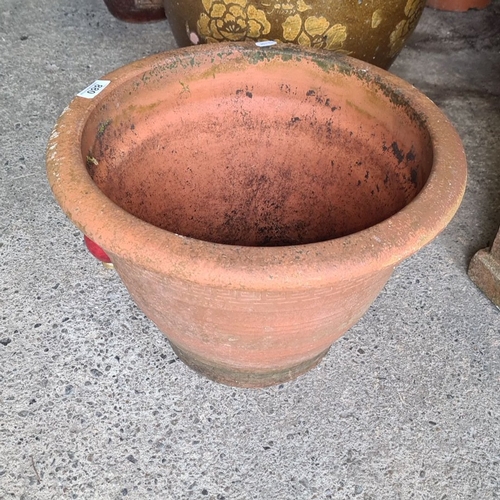 880 - Terracotta garden planter with a Greek key design. Approximately 50 cm in diameter and 40 cm in heig... 