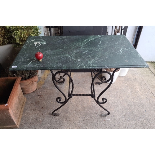 882 - Star Lot : Ornate wrought iron table with large green marble top. Approximately 70 cm high, 100 cm w... 