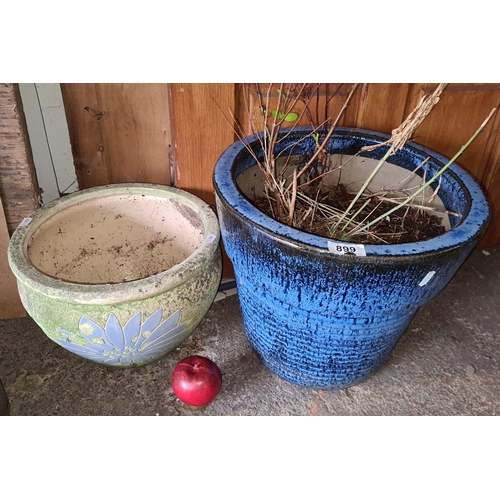 899 - Pair of ceramic garden pots. One has a green base with a blue floral design, the other is in a textu... 