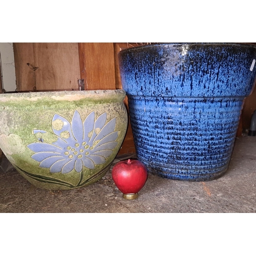 899 - Pair of ceramic garden pots. One has a green base with a blue floral design, the other is in a textu... 