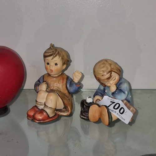 700 - A pair of West German Goebel Hummel figures of young seated boy and girl. Both in good condition wit... 