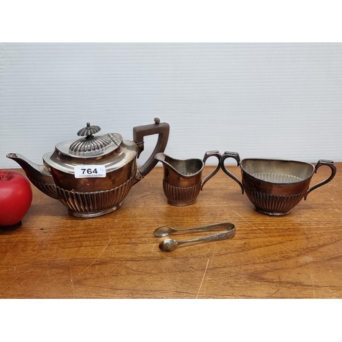 764 - An antique 3 piece Embossed silver plate tea service featuring semi ribbed forms includes teapot, a ... 