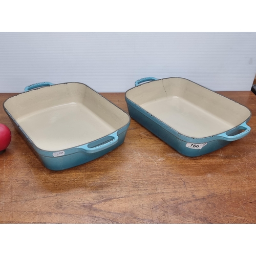 766 - Two very heavy cast iron 'Le Creuset' baking dishes. In an aqua blue shade. Similar on line for €272... 